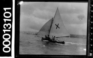 Yacht with a large 'X' emblem on the mainsail, Sydney Harbour