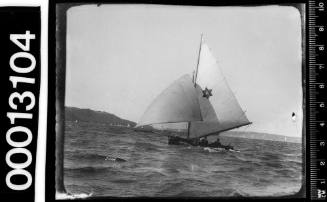 18-foot skiff on Sydney Harbour with a six-pointed star emblem on the mainsail