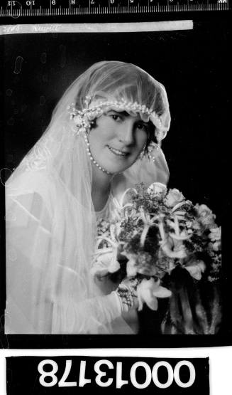 Portrait of a bride wearing a veil and holding a bouquet