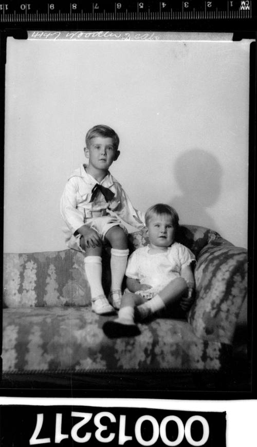 Portrait of two children sitting on a couch