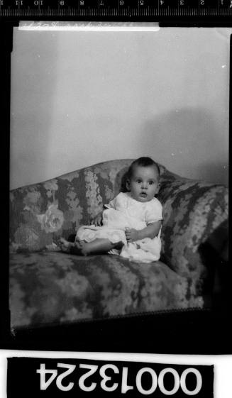 Portrait of a baby sitting on a couch
