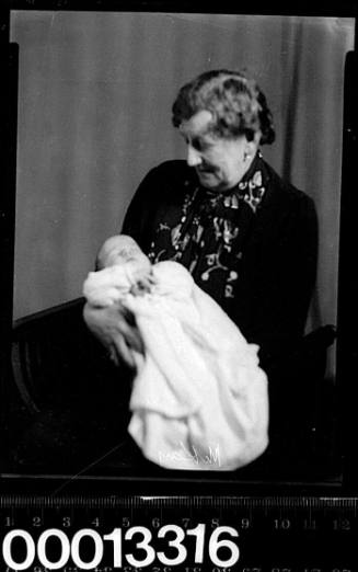 Portrait of a woman holding a baby