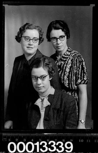 Group portrait of three women wearing glasses