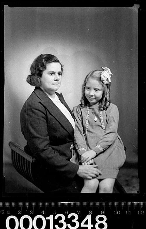 Portrait of a woman with a young girl sitting on her lap