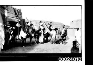 Mounted tribesmen in a West African fortified town with chief