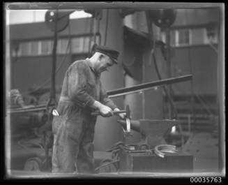 On board of SS ALLER with blacksmith working on an anvil.
