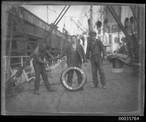 Image of three workers on deck of SS ALLER with lifebuoy reading 'ALLER BREMEN'.