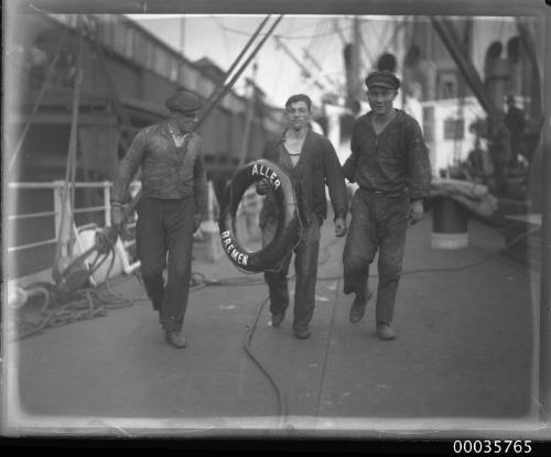 SS ALLER, three crew on deck on carrying a lifebuoy