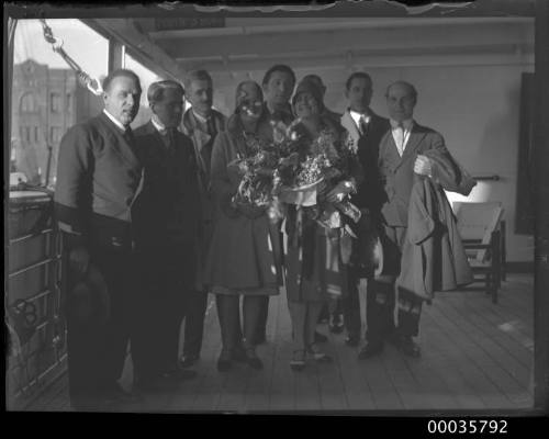 Passengers posing on covered deck of SS ORUNGAL