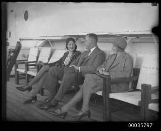 Three passengers seated on deck, TSS ORUNGAL,  AUSN Line