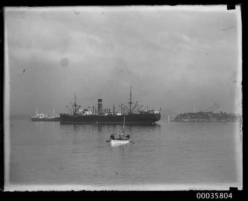 Two unidentified cargo ships and ships lifeboat in Athol Bight in Sydney harbour