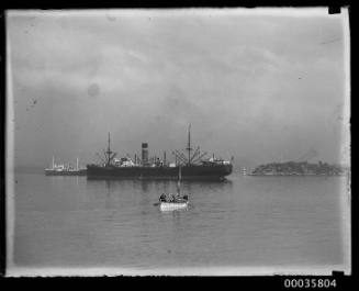 Two unidentified cargo ships and ships lifeboat in Athol Bight in Sydney harbour