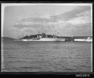 View of 3 warships and seaplane in harbour.