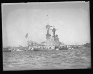 USS CALIFORNIA with pleasure craft in harbour.