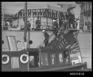 USS CALIFORNIA with senior officers leaving the ship.