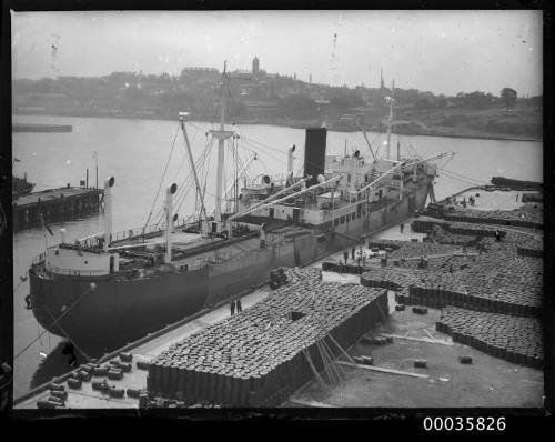 View of NEPTUNIAN unloading oil drums for H. C. Sleigh at Darling harbour, Sydney.