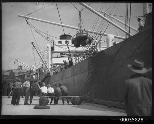 MV NEPTUNIAN with workmen unloading oil drums for H C Sleigh at Johnstons Bay in Sydney