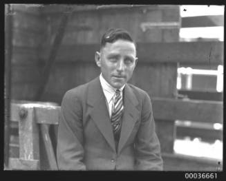 Head and shoulder portrait of a young man in a suit.