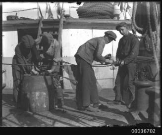 Crew splicing ropes on deck of C.B. PEDERSON.