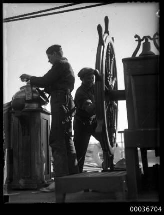 Crew at ships wheel on deck of C.B. PEDERSON.