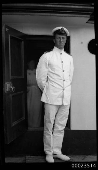 Portrait of a merchant marine officer standing in front of a doorway