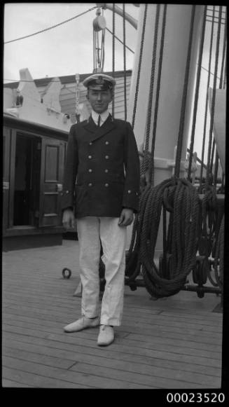 Portrait of a merchant marine officer standing in front of ship's mast