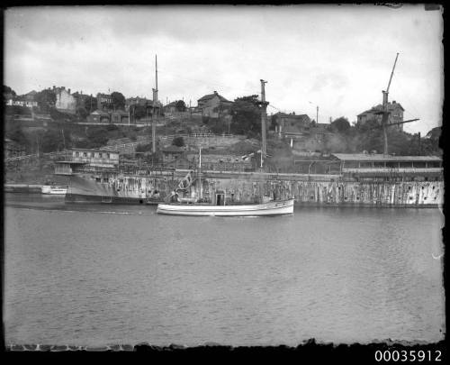 COAST GUARD passing a rusting hulk near Berry's Bay, Sydney New South Wales.