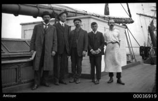 Captain Mathieson and crewmen standing on board ANTIOPE