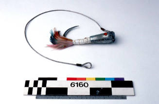 TUNA FISHING LURE, METAL HOOK WITH COLOURED FEATHERS (BLUE, ORANGE AND PINK) TAPED TO SHAFT WITH WHITE PLASTIC TAPE, TWO ROUND RED INSERTS TO IMITATE EYES, METAL CABLE ATTACHED TO HOOK