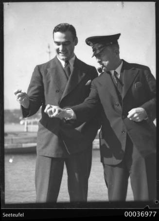 Count Felix Graf von Luckner, right, and an unidentified man squeezing coins on SEETEUFEL