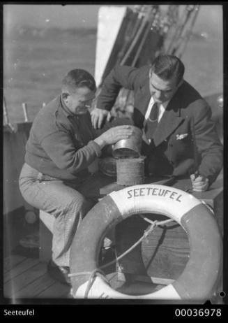Cook, Hohn Winter, on board SEETEUFEL with a visitor