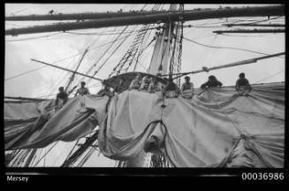 Crew attending to sails on board the training ship MERSEY