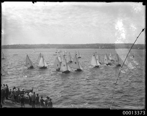 Spectators watching the start of an 16-foot skiff race