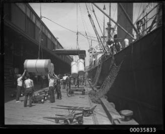 Unknown vessel unloading cargo at a wharf