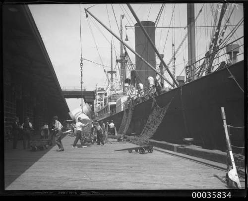 Unknown vessel unloading cargo at a wharf