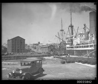 Unidentified vessel possibly the MOSEL unloading oil drums at Pyrmont wharves, Sydney, New South Wales.