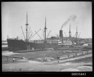 View of MOSEL unloading oil drums at Johnstons Bay, Sydney, New South Wales.