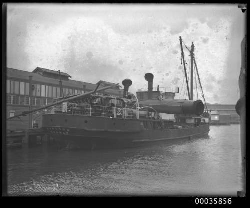 View of TYALGUM alongside wharf with broken mast.