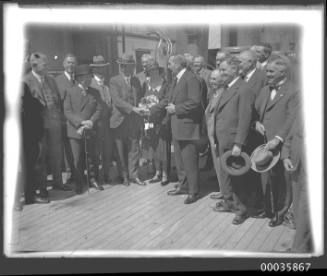 View of passengers or dignatories on deck of unidentified ship.