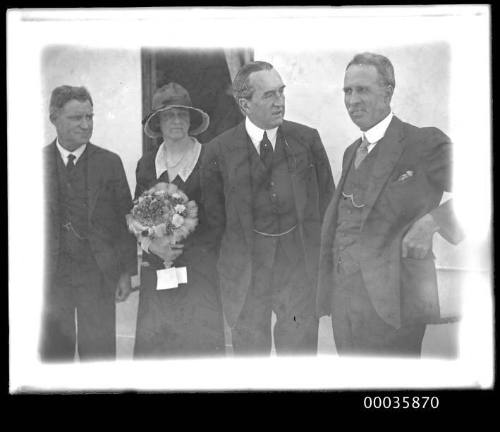 Portrait of four dignatories on deck of unidentified ship.