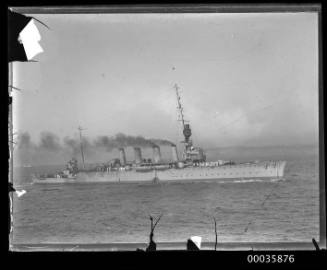 View of unidentified light cruiser underway at sea.