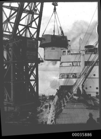 Titan crane loading gun turret to steamer.