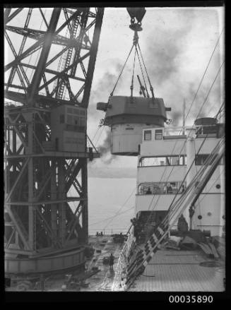 Titan crane loading gun turret to steamer.