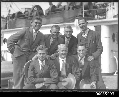 Group of seven male passengers on deck of SS RUNIC possibly at Millers Point, Sydney