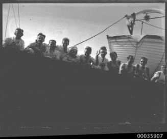 Eleven young crew members leaning over side of SS RUNIC possibly at Millers Point, Sydney