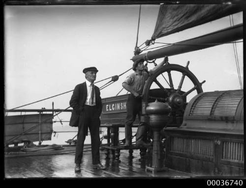 Deck view of ELGINSHIRE showing crew members at wheel