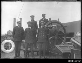 MOUNT STEWART - ship officers or cadets posing beside the ship's wheel