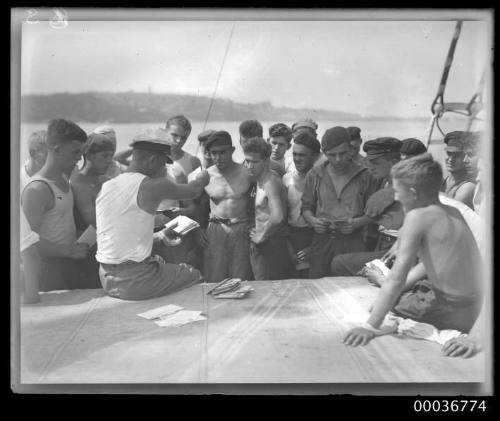 On deck of MAGDELINE VINNEN showing crew receiving mail