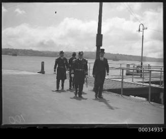 View of four dignitaries arriving from wharf at farm cove Sydney, New South Wales.