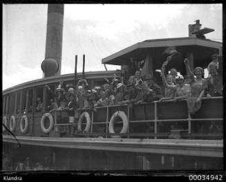 Group of waving passengers on board the ferry SS KIANDRA at Circular Quay